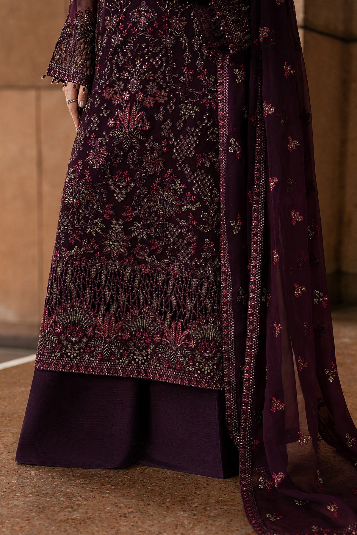 Purple embroidered traditional outfit with a matching dupatta on a neutral background
