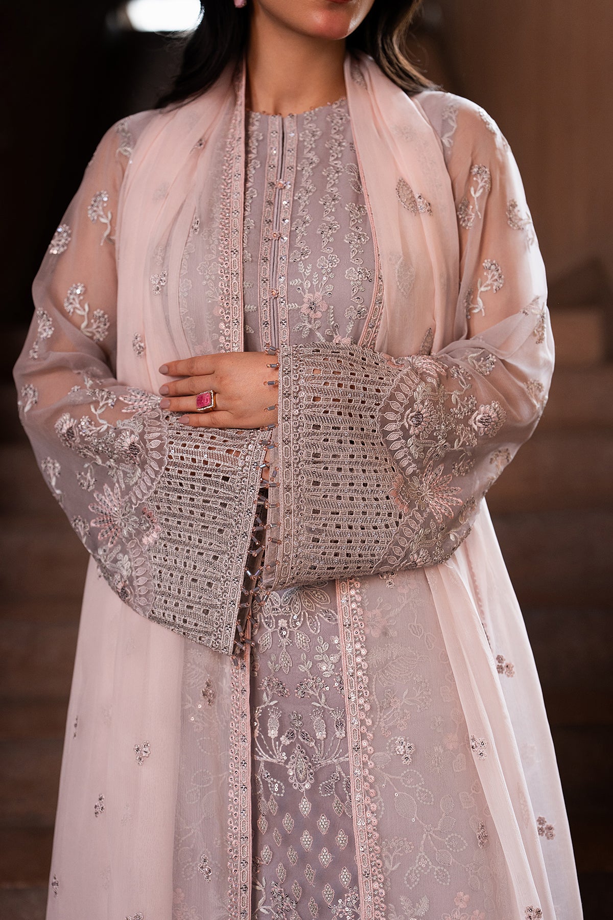 Traditional outfit with embroidered jacket and dupatta on a blurred background