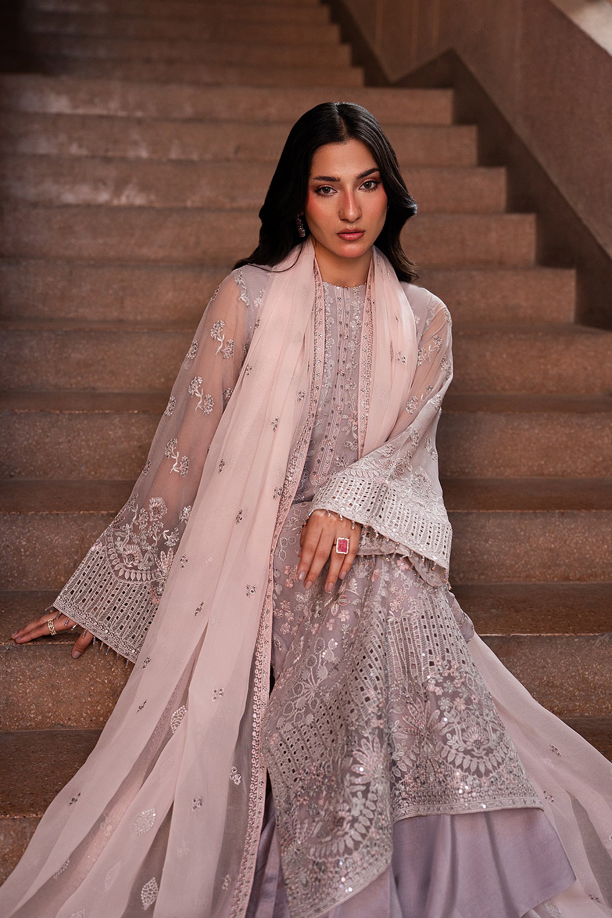 Woman in traditional outfit standing on a staircase