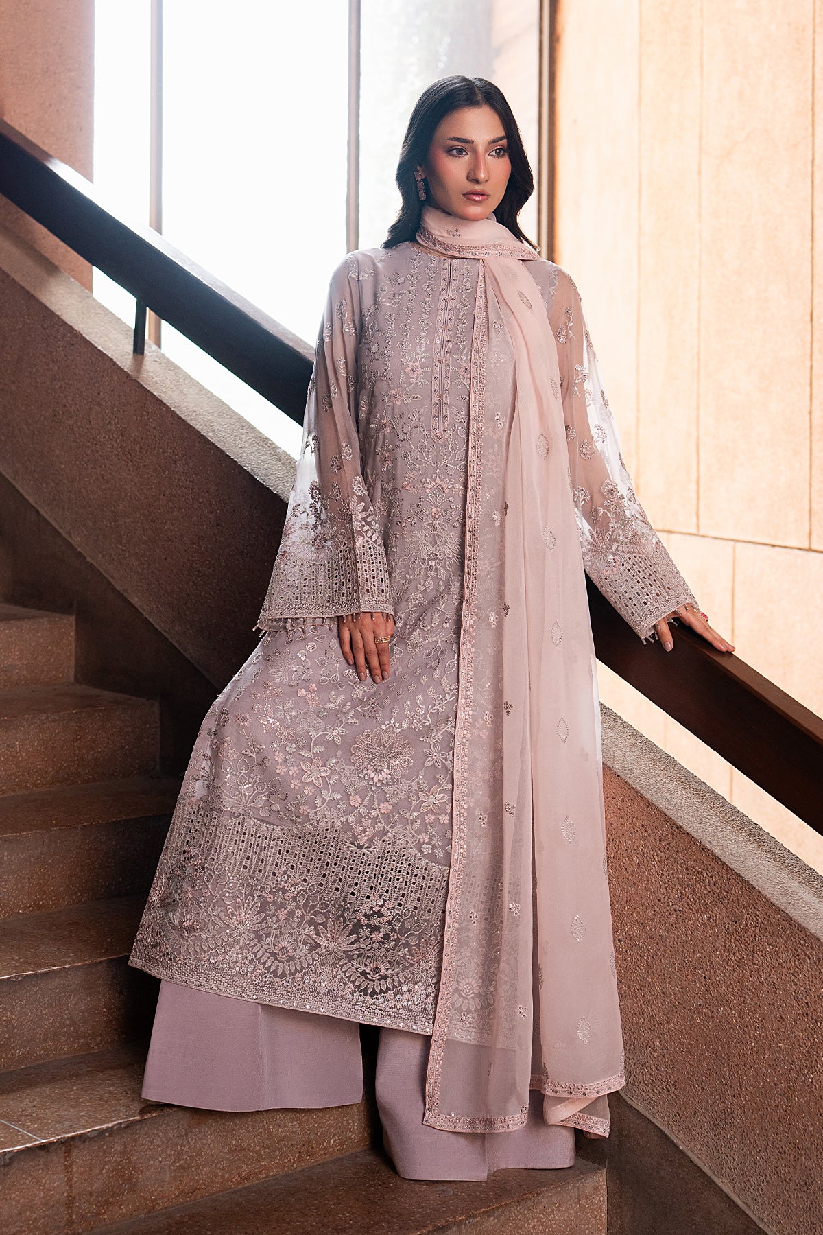 Woman in a traditional outfit standing on a staircase